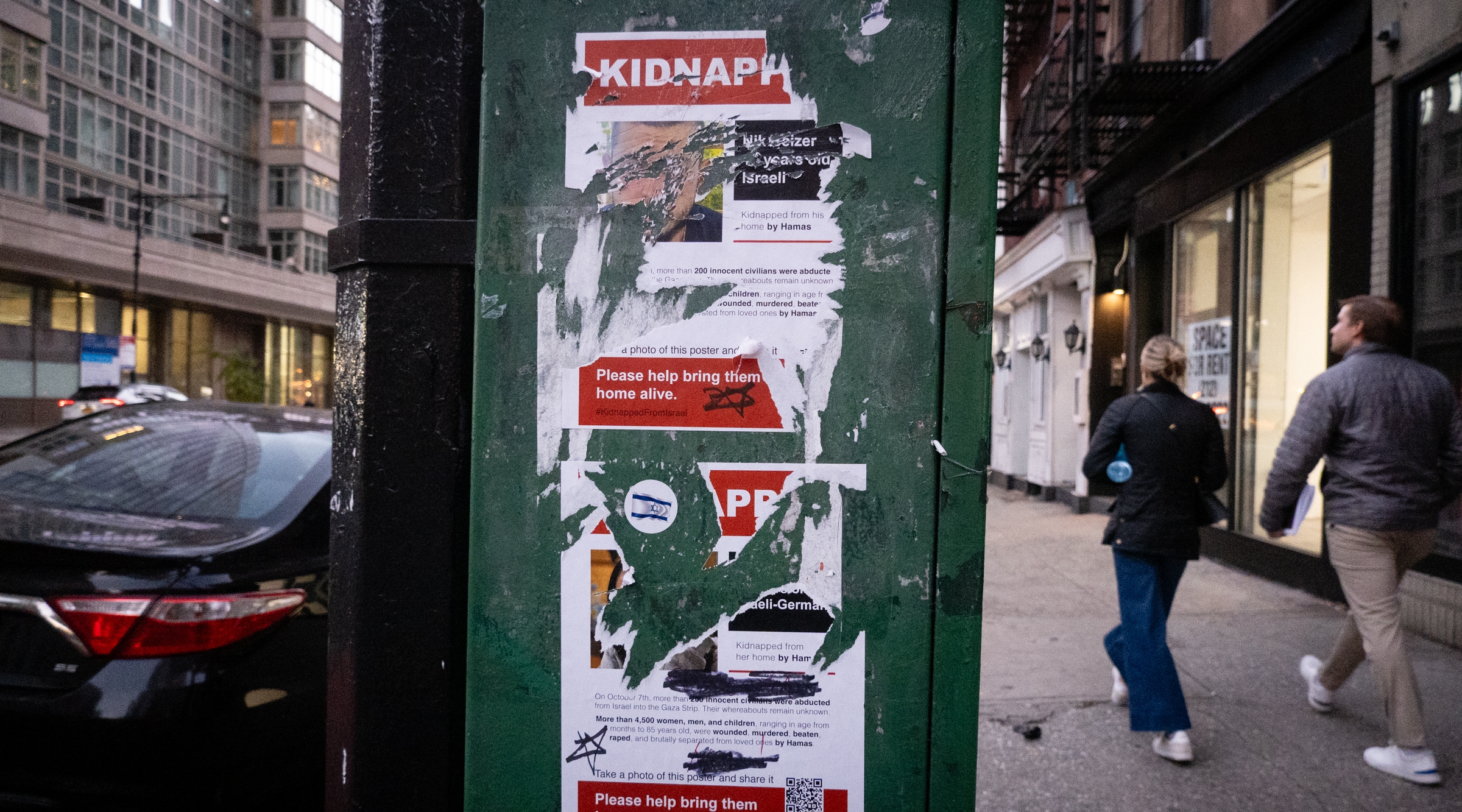 Defaced hostage posters in midtown Manhattan, Nov. 18, 2023. (Luke Tress)