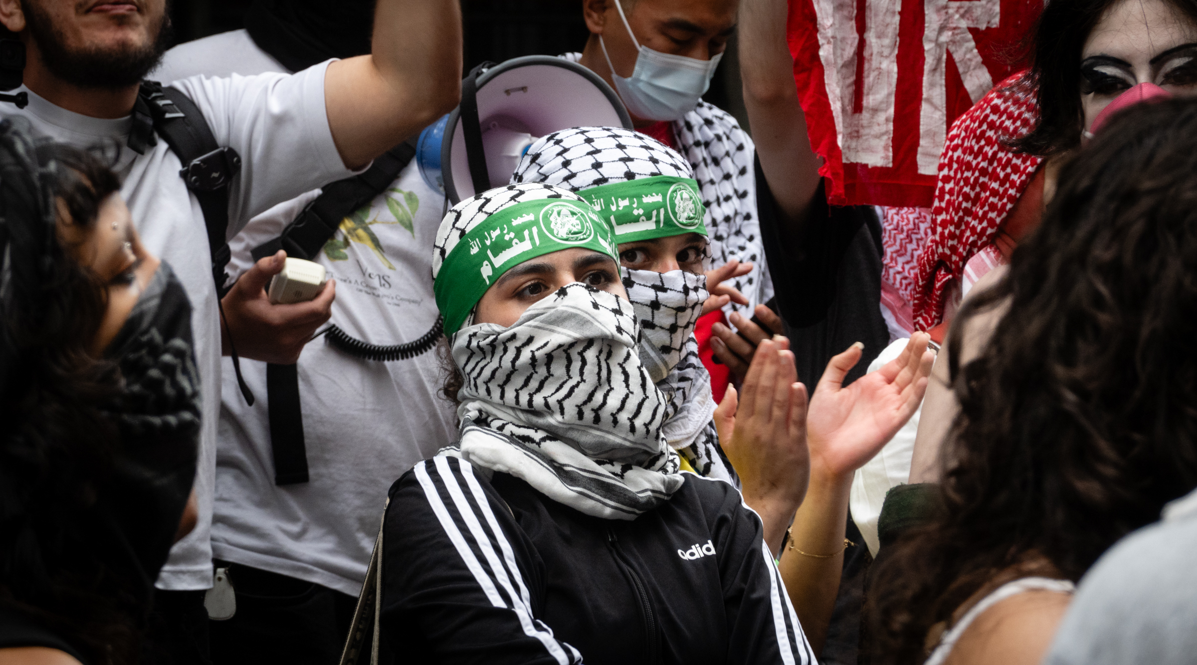 Anti-Israel protesters became increasingly bellicose after the spring semester ended, with activists at Baruch College and elsewhere expressing open support for terrorism by wearing Hamas headbands and bearing flags and symbols of terror groups, June 5, 2024. (Luke Tress)