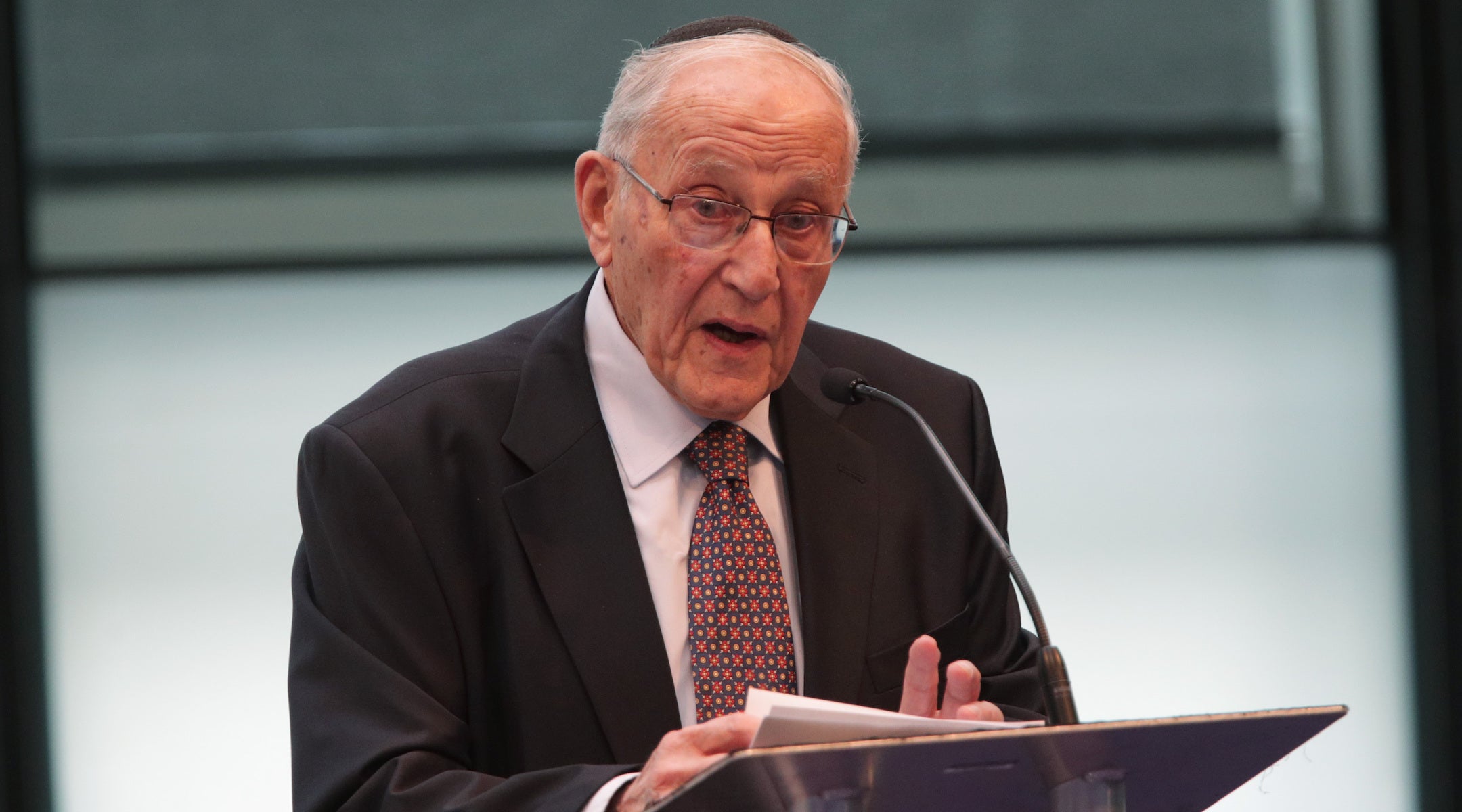 A photo of Goldberg speaking into a mic.