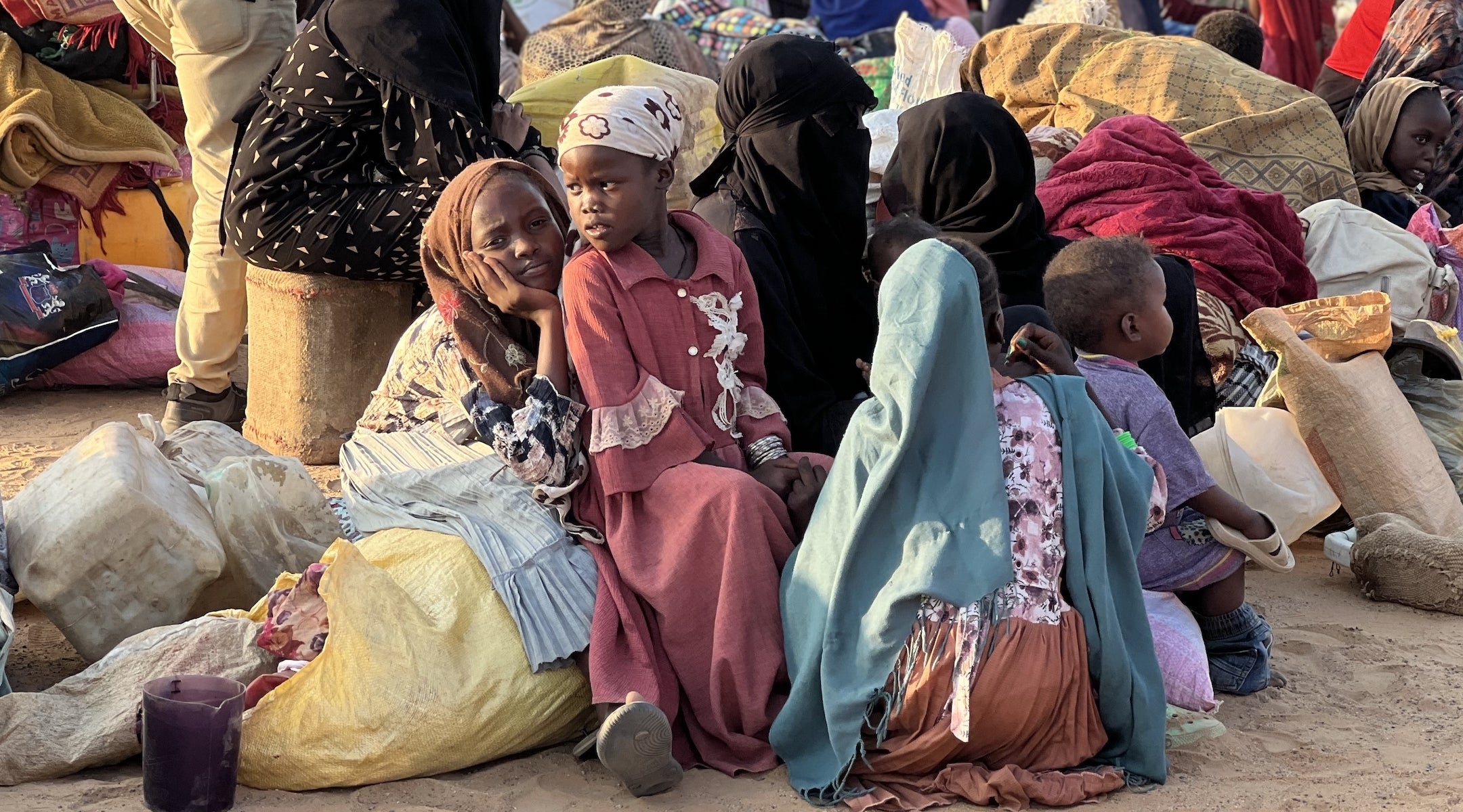Sudanese refugee children sit in a camp