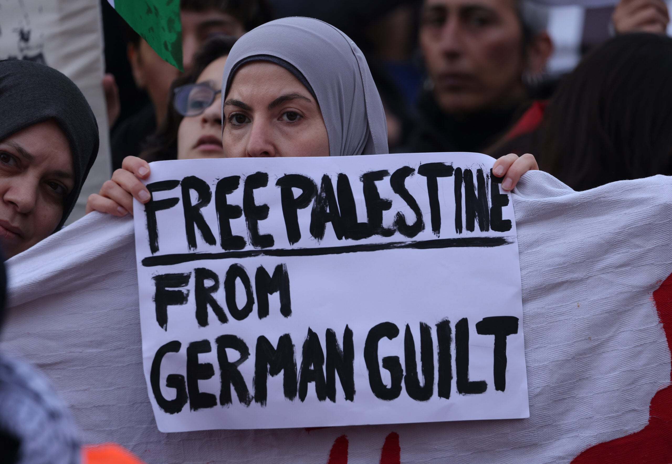 A woman holds a sign that reads 