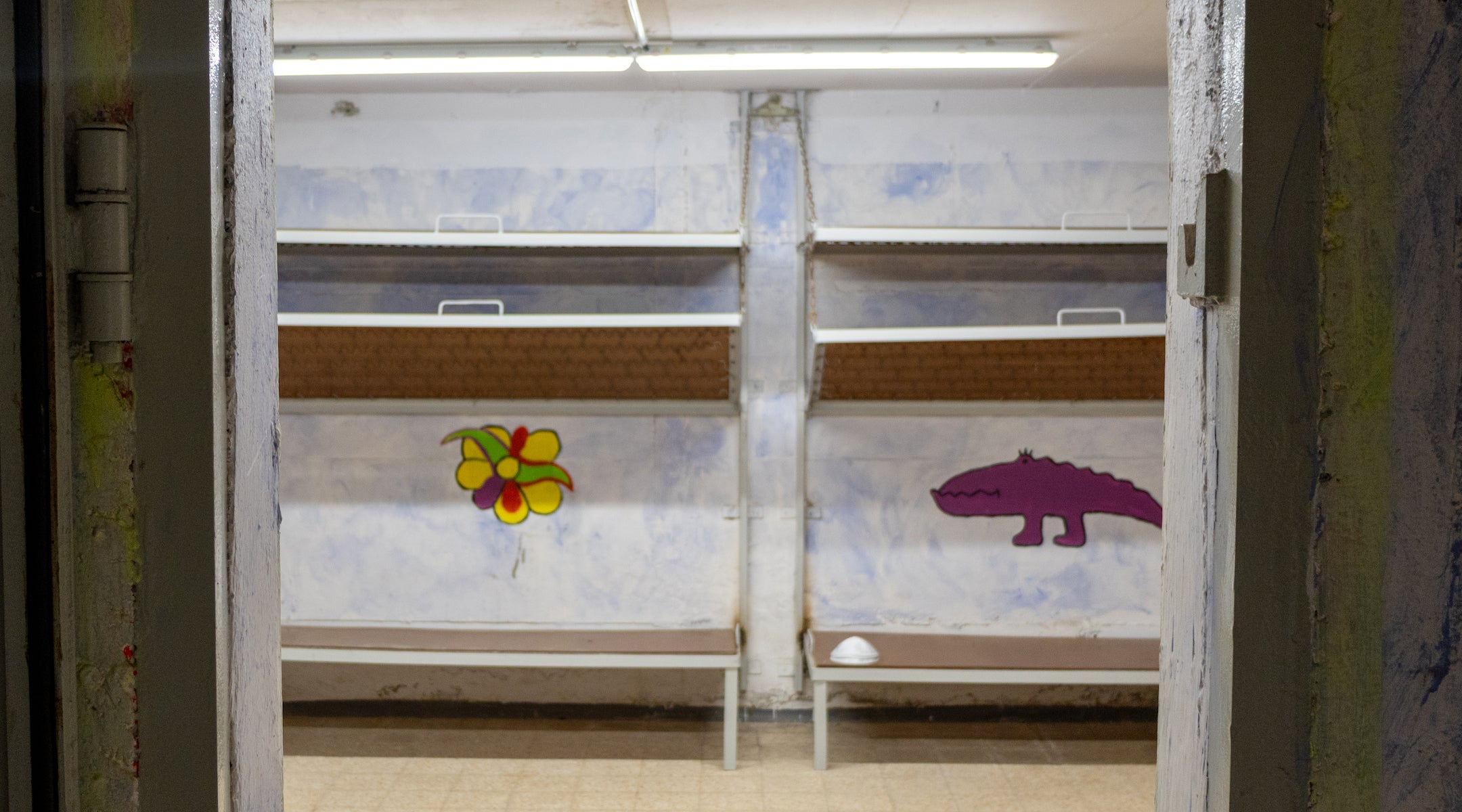 An image of a bunker with dinosaur murals.