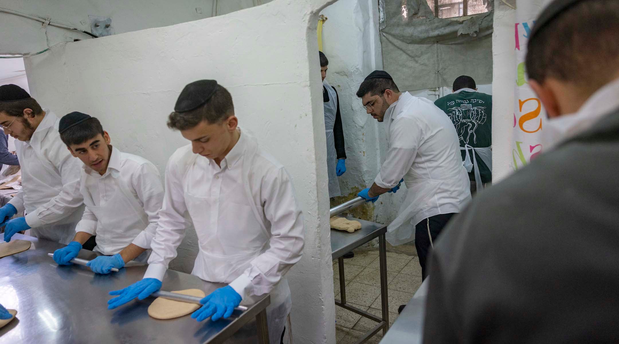 A photo of men baking matzos.